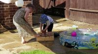 The kids play with a hose  by Main root channel